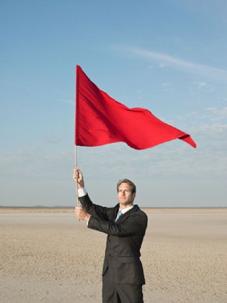 举着红旗仰望天空的外国商务男士图片